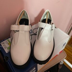 8.5 chunky white Mary Jane shoes with a silver buckle. New and unworn with tags.